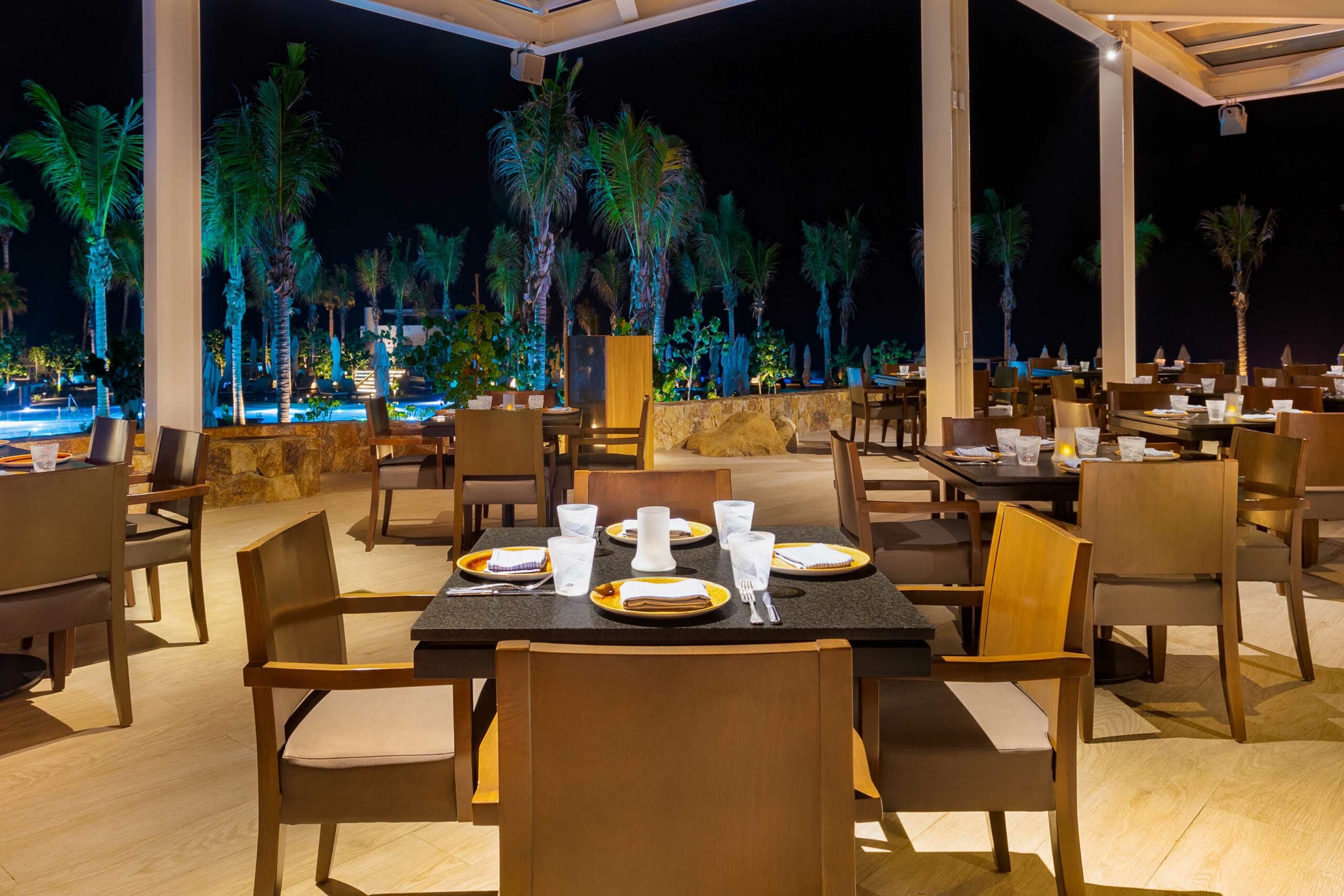 Fine dining Latitud 23.5 Steakhouse and Grill at Villa La Valencia with an evening view of the restaurant towards the pools.
