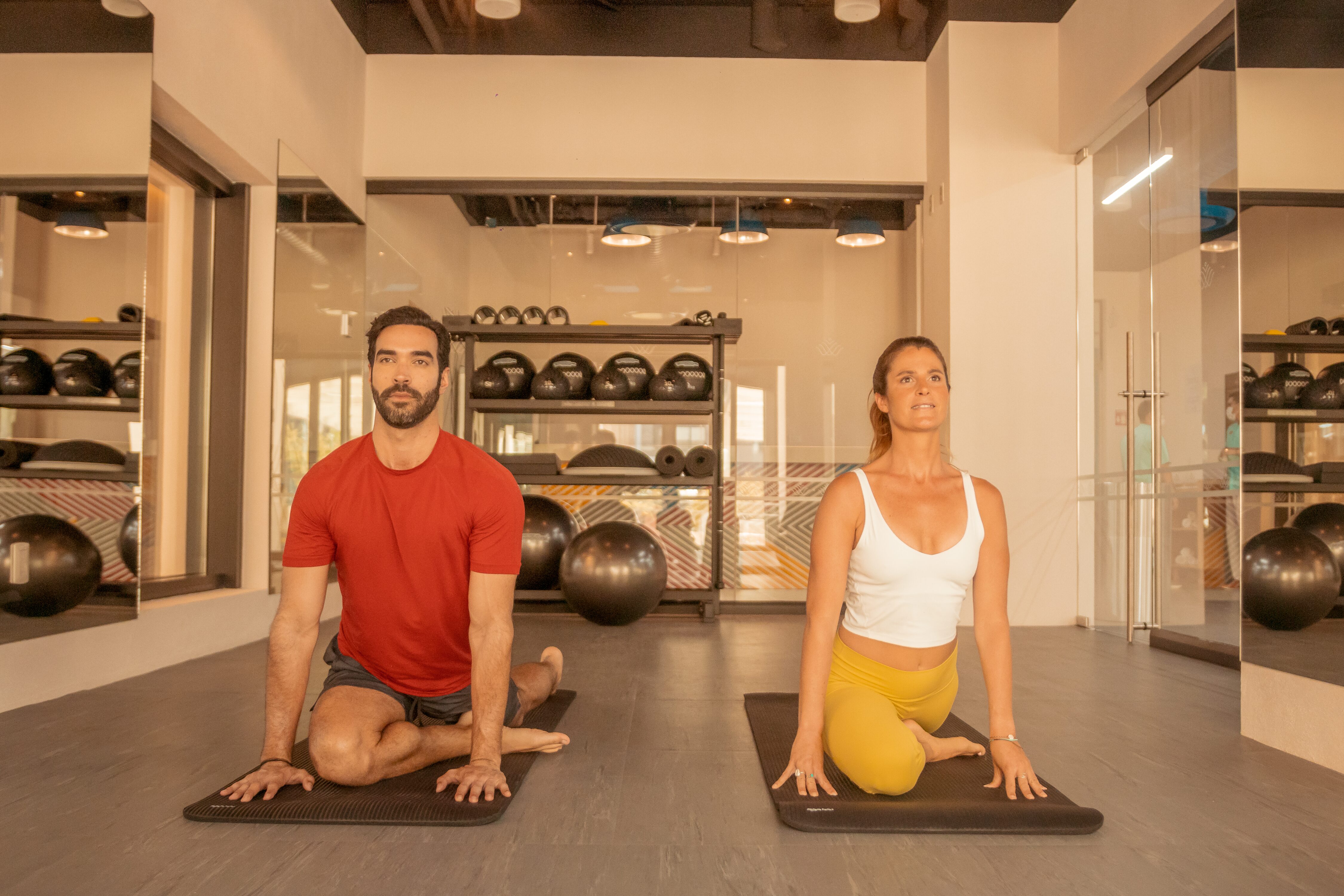 Image of a couple doing yoga in fitness center gym of Villa La Valencia in Cabo San Lucas, Mexico